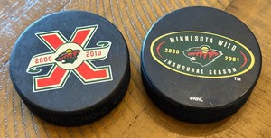 lot 235 image: (2) Minnesota Wild Innaugural Season Hockey Pucks