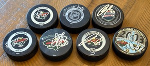 lot 7 image: (7) Minnesota Wild Signed Hockey Pucks