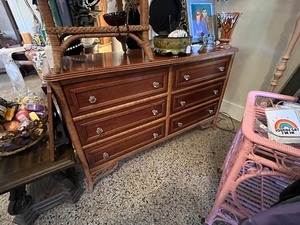 lot 9 image: Vintage Wooden Dresser with Wicker Accents and Six Drawers
