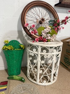 lot 102 image: Eclectic Home Decor Lot with Flower Clock, Wicker Table, Bicycle Wheel Art, and Accessories