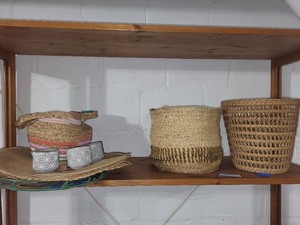 lot 51 image: Collection of Woven Baskets, Decorative Placemats, Stoneware Cups, and Glass Serving Tray