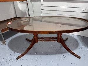 lot 80 image: Vintage Oval Glass Coffee Table with Wooden Pedestal Legs