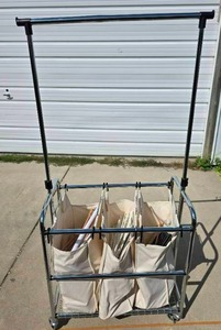 lot 1025 image: Tri-pocket Laundry Cart full of clothes-hangers