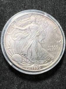 lot 12 image: 1990 AMERICAN SILVER EAGLE 1 TROY OZ .999 FINE SILVER IN AIRTITE