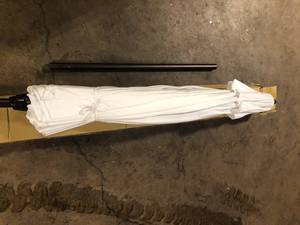 lot 12 image: California Umbrella 9 ft. Aluminum Auto Tilt Patio Umbrella in White Olefin Customer Returns See Pictures