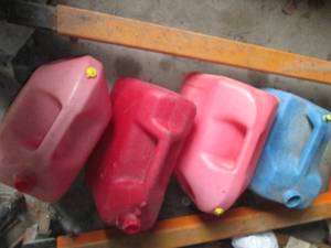 lot 127 image: Cluster of 5-gallon gas and Kerosen...