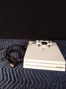 lot 63 image: Sony PS4 with controller and cords
