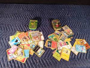 lot 65 image: 2 Pokmon tins with 50 Pokmon trading cards in each