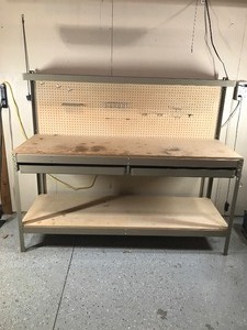 lot 1 image: Metal framed work bench with 2 drawers, shelf and peg board on the back