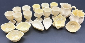 lot 163 image: Belleek Porcelain Limpet pattern Egg Cups and Neptune Shell Salt Cellars, sugar and creamer Collection
