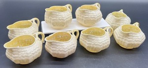 lot 175 image: Set of 8 Belleek Limpet Creamers Ivory with Yellow Interior