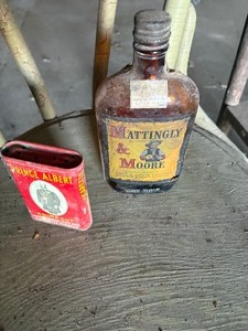 lot 142 image: Whisky bottle and Tobacco can