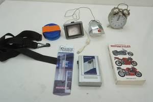 lot 178 image: Sanyo Walkman, Sharp Wind-Up Alarm Clock, Garmin, Straps, Dorcy Light, Motorcycle Book