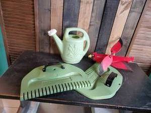lot 60 image: Thexceptional Leaf Rake new, Vintage Cardinal whirligig, and Watering Can
