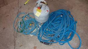 lot 120 image: 2- Blue Hoses, Electrical Cords and Almost Full Propane Tank.