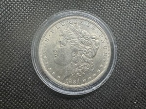 lot 52 image: 1884 O AU Morgan Dollar. Original Surfaces, Sigma Verified .90 Fine Pre 1900
