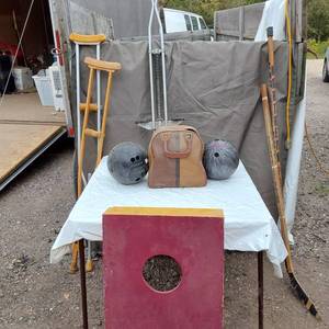 lot 70 image: Vintage sports equipment lot including Brunswick Black Beauty and AXIS bowling balls, Pogo stick, hockey sticks, and additional items.