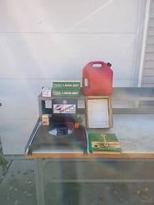 lot 72 image: Lawn-Boy Manuals, Briggs & Stratton Sign, Mower Deck, and Texaco Farm Guide Lot