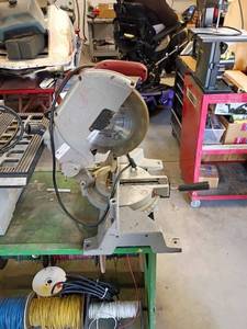 lot 84 image: Milwaukee Power Miter Saw with Red Handle