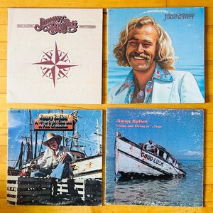 lot 171C image: LR - Set of 4 Jimmy Buffett Vinyl Records - Changes in Latitudes, Havanas Daydreamin, A White Sport Coat, Living and Dying in 34 Time