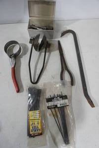 lot 313 image: Hardware Lot Small ratchet and sockets, oil filter wrench, long needle nose pliers, pry bar, zip ties