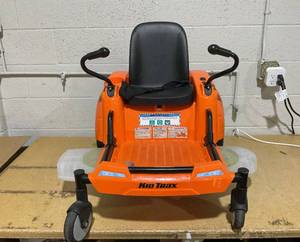 lot 104 image: Kid Trax Zero Turn Lawn Mower 12-Volt Ride-On