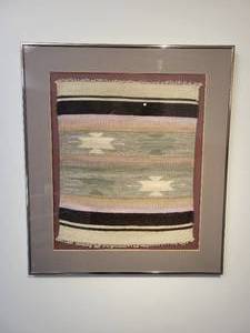 lot 25 image: A Nicely Framed and Matted Southwest Style Rug.