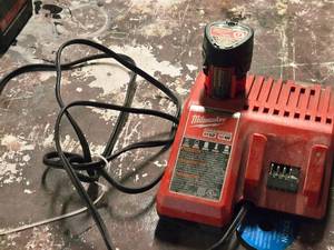 lot 101 image: Milwaukee M12M18 Battery Charger with M12 1.5Ah Battery Pack