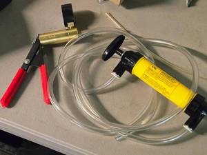 lot 110 image: (1) Pennzoil Multi-Use Hand Pump and (1) Handheld Vacuum Pump