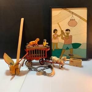 lot 38 image: Whimsical Pinata Artwork, Cast Iron Circus Truck, and toys.