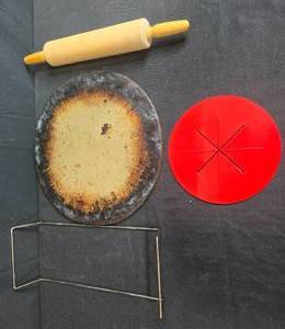 lot 78 image: Pizza Stone Baking Set with Rolling Pin, Metal Rack, and Slicer Guide