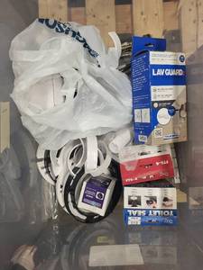 lot 16RC image: Assorted Plumbing Supply Lot with Seals, Flanges, Hoses, and Fittings