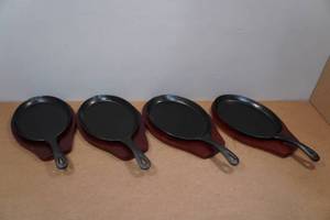 lot 171 image: 4 Winco Cast Iron Skillets with Wood Underliner