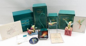 lot 57 image: WDCC Peter Pan - Tinkerbell Lot of 4 Figures  Extras Pins, Lenticular Card, etc.