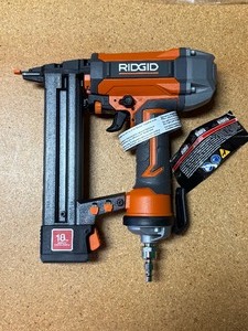 lot 34 image: Ridgid Pneumatic 18-Gauge 1-12 in. Finish Stapler with Swivel Connector -NEW -out of box- MSRP $109