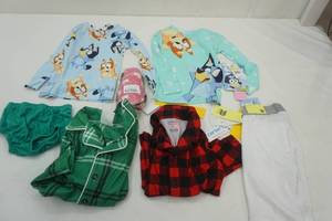 lot 363 image: 5T Bluey Pajama Tops, Soccer Shin Guards and Other Kids Cloths