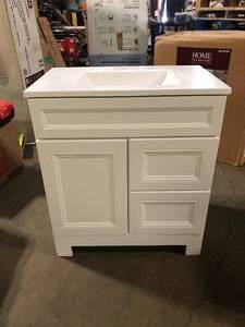 lot 42 image: Home Decorators Collection Sedgewood 30.5 in. W x 18.75 in. D x 34.375 in. H Single Sink Bath Vanity in White with Arctic Solid Surface Top Slight Damage on Bottom  Customer Returns See Pictures