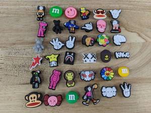 lot 111L image: 36 Fun KAWS Shoe Croc Charms - Brand New