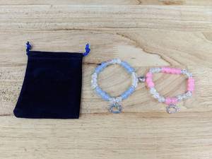 lot 251 image: Hello Kitty Beaded Elastic Bracelet Duo, Pink and Blue Magnetic Heart - Brand New
