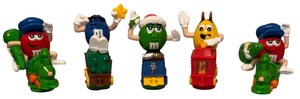 lot 199 image: Huge Bundle of M&Ms Christmas Train Series toy figure, specifically the green M&M character on a train car