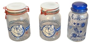 lot 049 image: Set of two vintage Pillsbury Doughboy Poppin Fresh glass canisterAnchor Hocking Pietro Gobeo blue floral glass kitchen canister