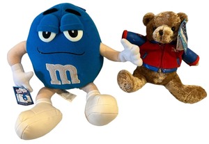 lot 179 image: M&M plush bear Bundle M and Ms Mandm Small Plush, Blue,M&Ms plush teddy bear wearing a varsity jacket.