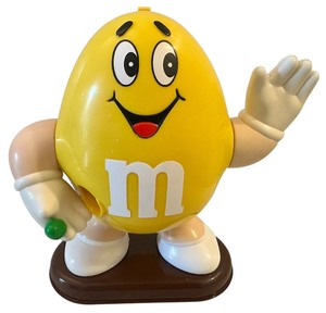lot 177 image: Vintage M&Ms candy dispenser featuring the Yellow M&M character