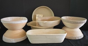 lot 132K image: O - Pampered Chef Baking Bowl, Stoneware Bakeware, and 5 Bread Proofing Baskets with Liners