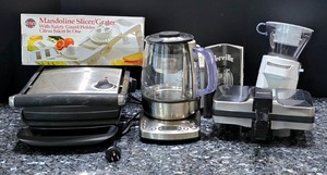 lot 235K image: K - Lot of Small Kitchen Appliances and Mandoline Slicer including Breville Tea Maker, Grills, and Food Processor Attachments