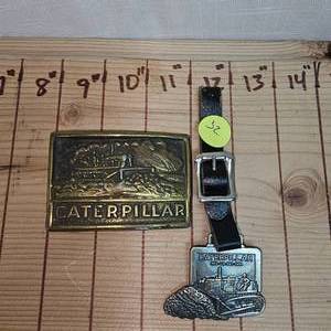 lot 32 image: Caterpillar Watch Fob and Belt Buckle