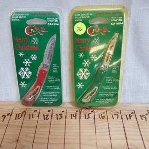 lot 76 image: CASE Merry Christmas Knives in Red and Green(2)