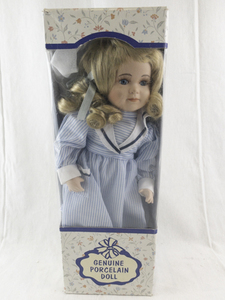 lot 142 image: Genuine Porcelain Doll with Blonde Hair in Blue Striped Dress