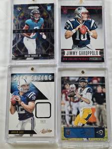 lot 46 image: Jimmy Garoppolo Rookie 2014 Panini Rookies and Stars, Jared Goff Rookie 2016 Panini Prestige, Biran Thomas Jr. Rookie 2024 Panini Prizmatic, Andrew Luck 2014 Panini Absolute Star Gazing Patch