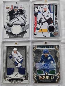 lot 89 image: Logan Couture 2014-15 Upper Deck Game Jersey Patch, Arshdeep Bains 2024-25 Upper Deck Artifacts Rookies Auto Gold Materials Patch 1149, Jonathan Quick 2018-19 Upper Deck Game Jersey Patch, Ondrej Palat 2018-19 Upper Deck Artifacts Patch 106165